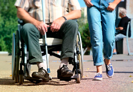 Elderly man sitting in wheelchair outside