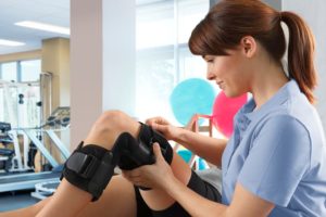 Therapist Adjusting Patient’s Knee Brace